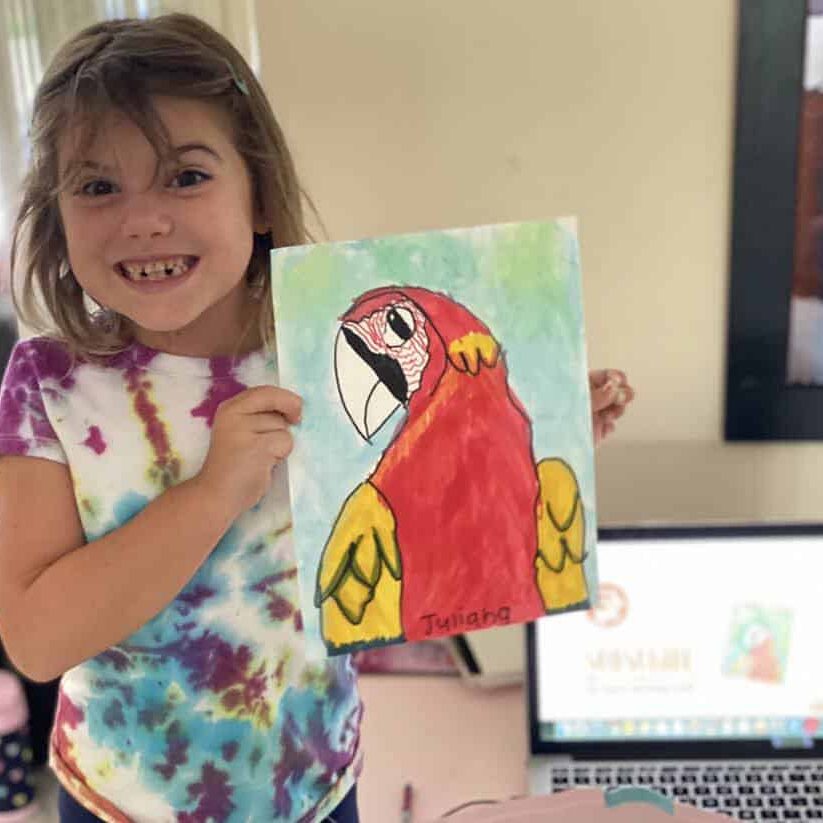 Child showing off artwork